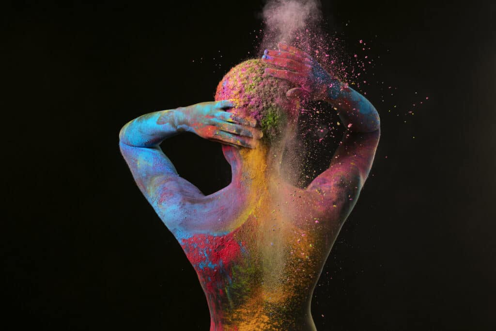 medium-shot-black-woman-posing-with-colorful-powder